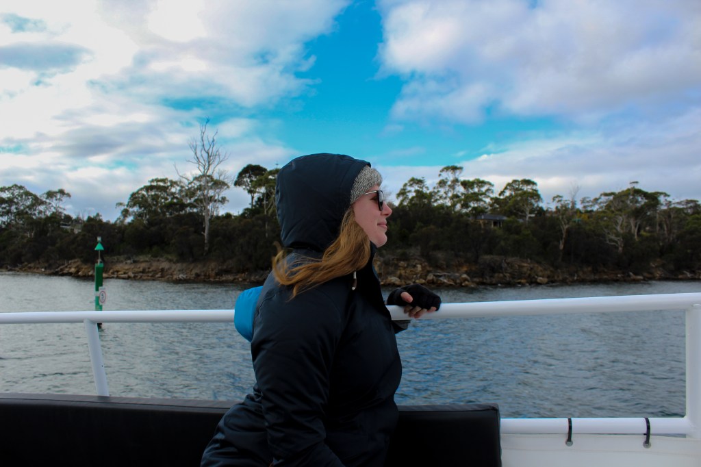 Blonde woman (Sapphire) sitting on a boat.