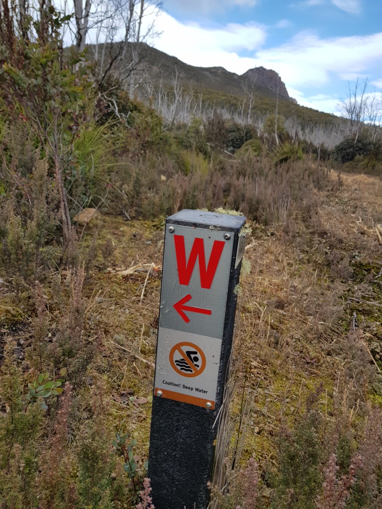 The sign reading "no swimming - deep water" 