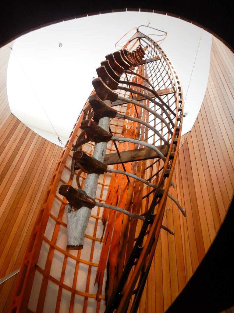 A canoe encasing a whale spine hangings in the middle of the spiral staircase to the restaurant, an homage to the aboriginal custodians of the land.